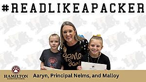 This is an image with a male student, a principal, and a female student