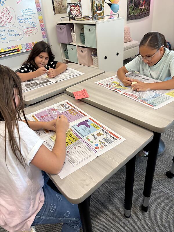 Students working on "Dinosaur Egg" project