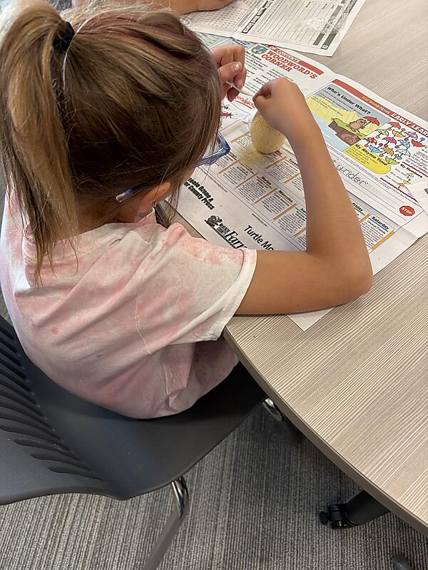 Students working on "Dinosaur Egg" project