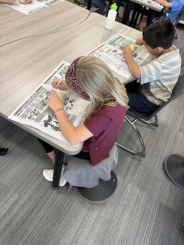 Students working on "Dinosaur Egg" project