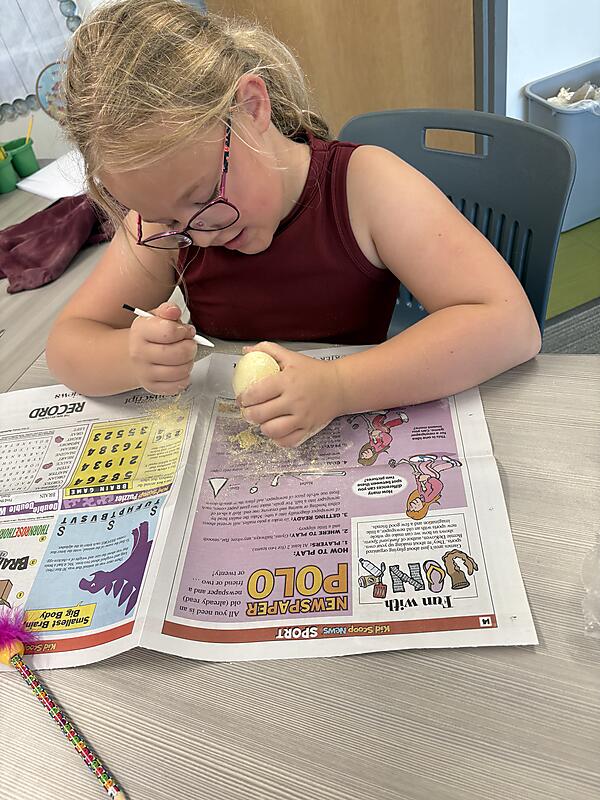 Students working on "Dinosaur Egg" project