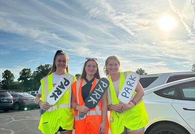 photo of girls standing with signs that say "park"