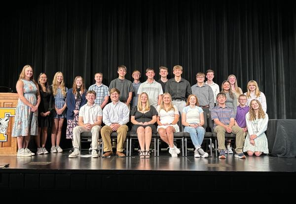 a group of students pose on stage