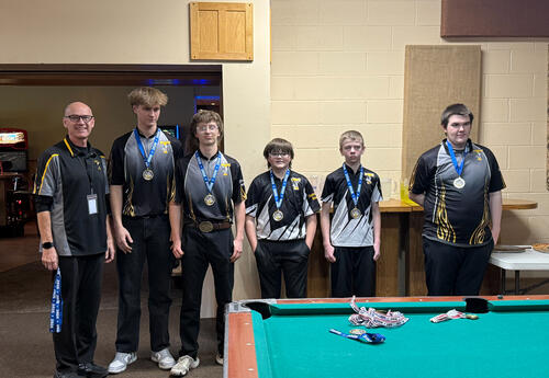 boys lined up wearing uniforms and medals around their necks