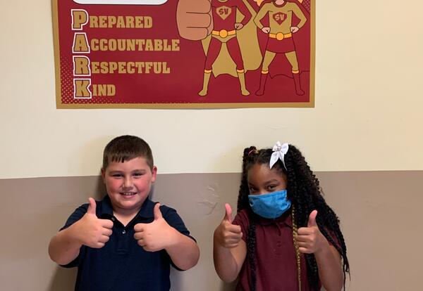 Two students giving a thumbs up