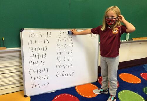Students in front of a list of math problems