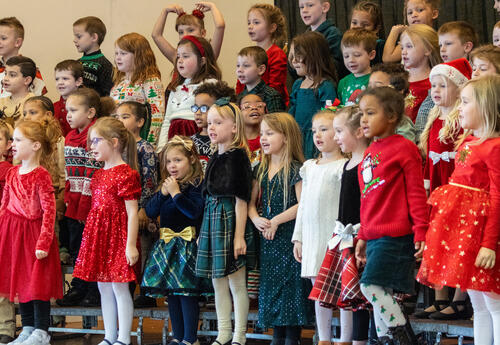 Elementary students sing at a holiday concert