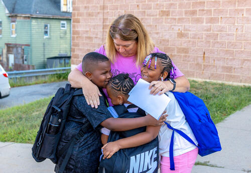 Counselor Fisher hugs arriving students