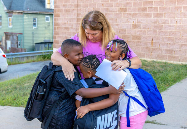 Counselor Fisher hugs arriving students