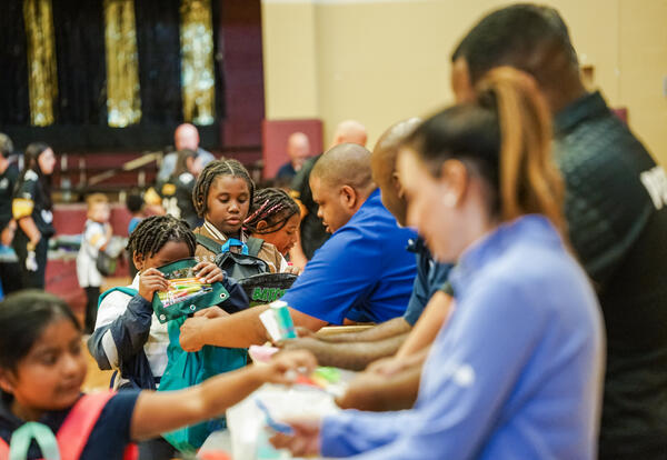 Kids collect supplies to put in their packs