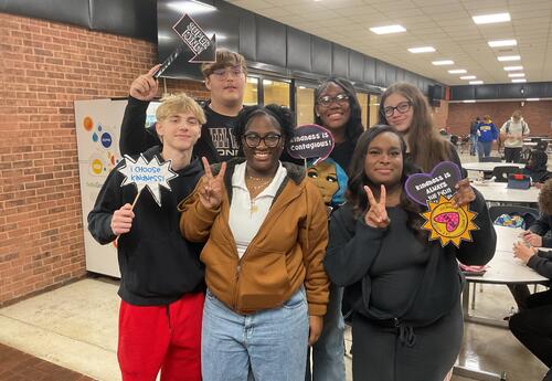 Six students smile at lunch