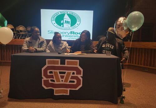 Ryan Cameron surrounded by family as she signs