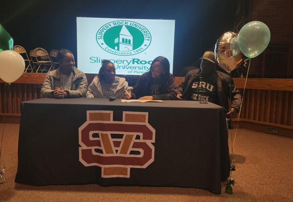 Ryan Cameron surrounded by family as she signs