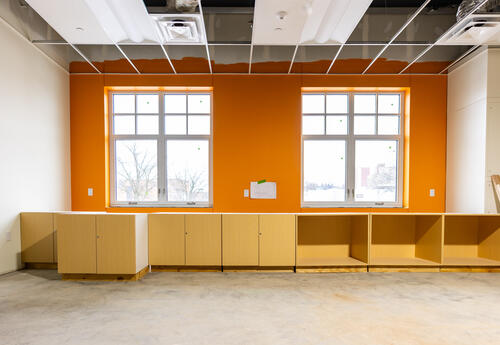 A portion of a classroom under construction, with an orange wall