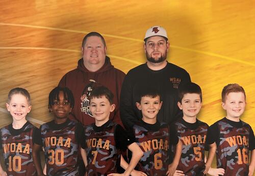 youth basketball players and coaches pose for group photo