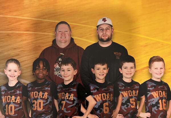 youth basketball players and coaches pose for group photo