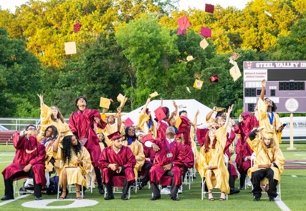 Graduates toss their caps