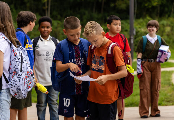 Two middle school students look at a schedule