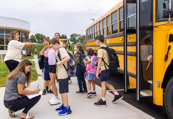 Students get off the bus at SV Elementary