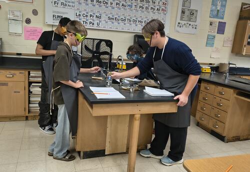 Students work on an experience at a lab table