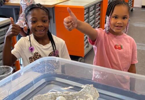 Students give a thumbs up