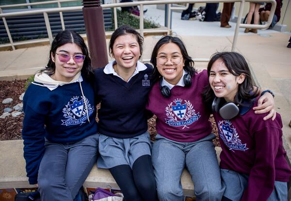 Smiling students arm in arm
