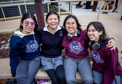 Smiling students arm in arm