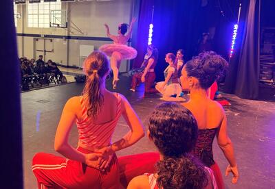 Backstage view of dancers on stage