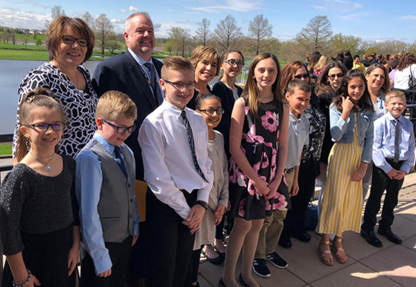 district administrators and students at awards ceremony