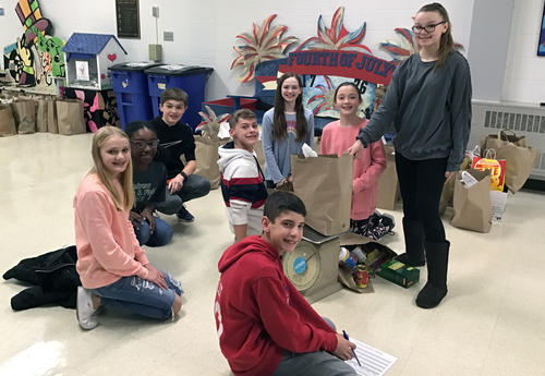 students weighing collected food