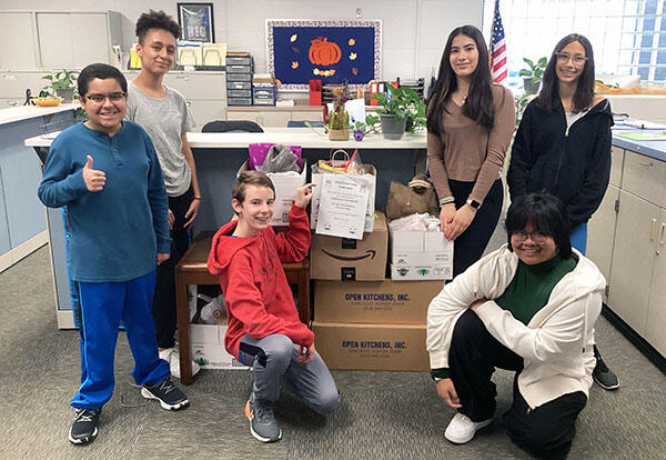 Students pose with candy collection from Treats for Troops