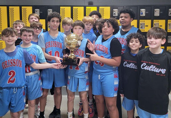 Grissom 6th/7th Grade Boys' Basketball team proudly pose with basketball trophy