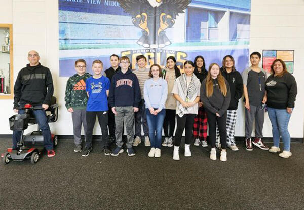 Group of Prairie View twelve students and two teachers pose for February students of the motnth