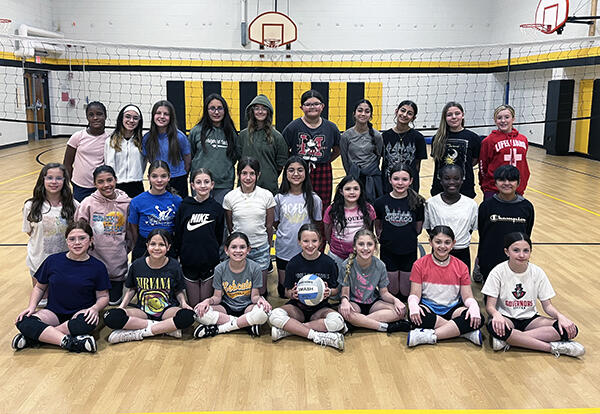 Bannes girls' volleyball team pose proudly in school gym