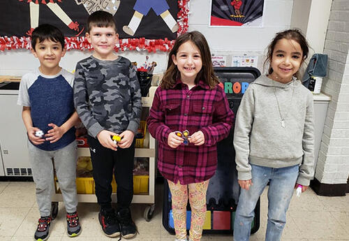 Students smile and pose proudly after being named PBIS Falcon Feather winners
