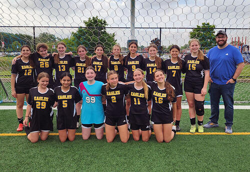 Prairie View girls' soccer team pose proudly with coach after winning championship