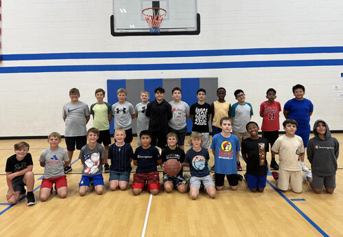 5th Grade Boys basketball team poses for picture in school gym