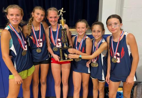 Grissom girls' cross country team pose proudly with SWIC conference trophy