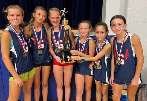 Grissom girls' cross country team pose proudly with SWIC conference trophy