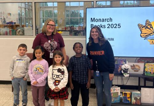 Students pose with proudly with librarians after presentation