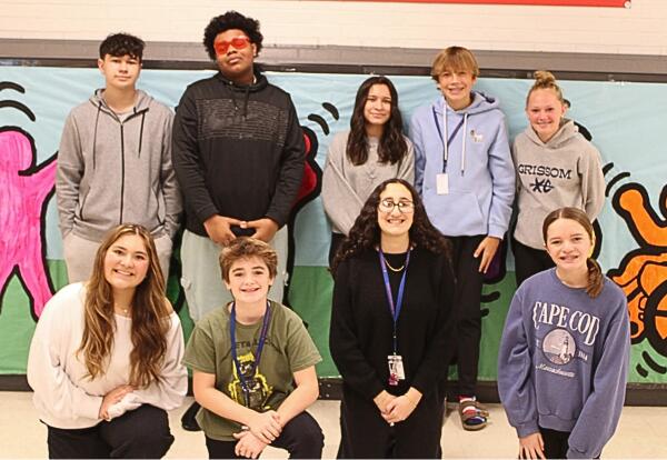 Grissom’s Eighth-Grade Advisory Committee pose proudly after fundraiser in hallway