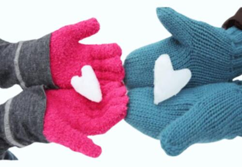 Two pair of hands wearing gloves holding snowflake hearts