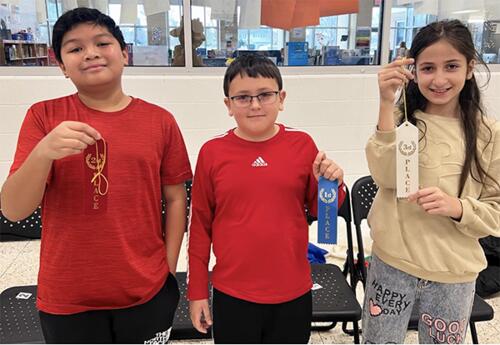 Keller Spelling Bee winners pose proudly with ribbons after spelling bee