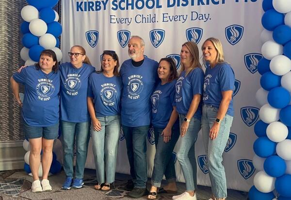 Six KSD 140 employees at Institute Day pose for a picture with keynote speaker Gerry Brooks