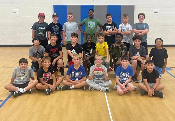 McAuliffe 5th grade boys' basketball team pose in school gym after practice