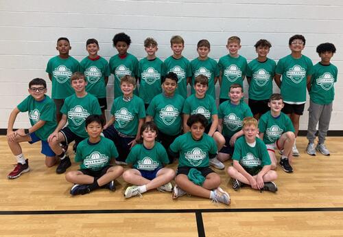 Millennium boys' basketball team pose proudly in school gym after practice