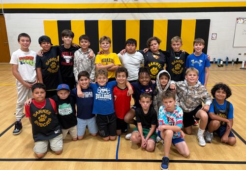 Bannes boys' basketball team pose proudly in school gym after practice