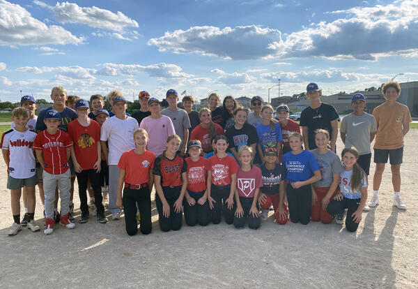 Grissom's boys and girls softball teams pose for picture together on softball field after last practice of the year