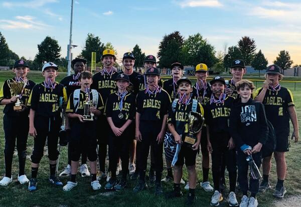 Prairie View boys' softball team pose proudly with trophies and medals after championship game
