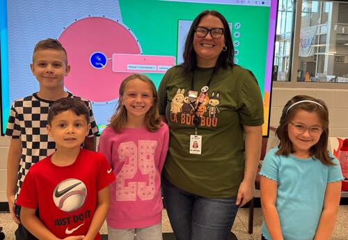 Four Keller students pose with librarian from the Tinley Park Library after presentation
